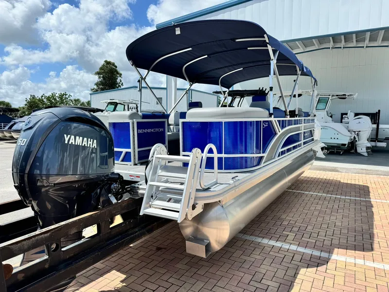 Slide: The Image of 2024 Bennington 22 SSR-SPS pontoon boat with Yamaha engine, parked outdoors. - 5