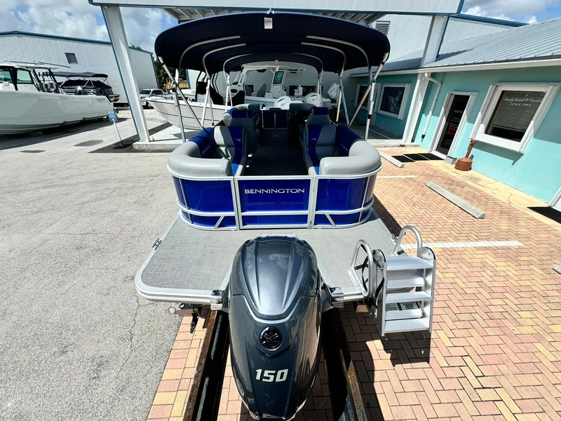 Slide: The Image of 2024 Bennington 22 SSR-SPS pontoon boat with Yamaha 150 engine, docked at marina. - 6