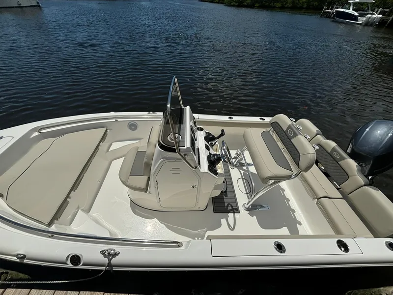 Slide: The Image of 2025 Key West 189 FS boat with seating, docked on calm water. - 6