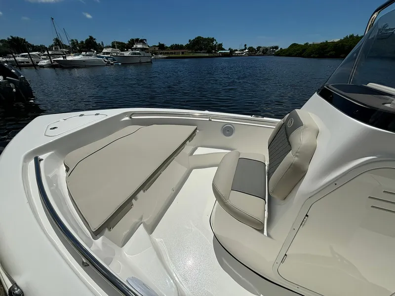 Slide: The Image of 2025 Key West 189 FS boat with beige seating, docked by a marina. - 8