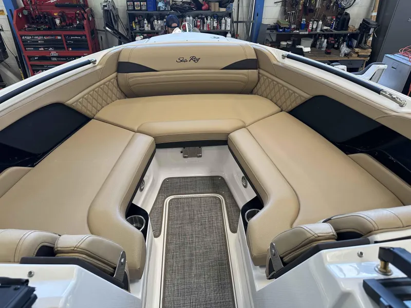 Slide: The Image of 2025 Sea Ray 280SLX boat interior with beige seating and modern design. - 12