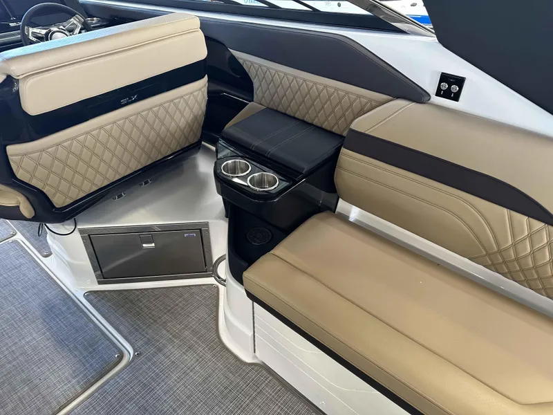 Slide: The Image of 2025 Sea Ray 280SLX interior with beige quilted seating and cup holders. - 7