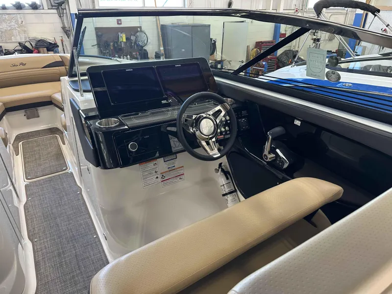 Slide: The Image of 2025 Sea Ray 280SLX boat interior with modern dashboard and steering wheel. - 9