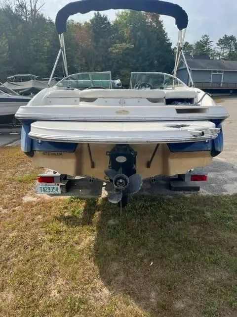 Slide: The Image of 2005 Monterey 194 FS boat, rear view, parked on grass. - 4