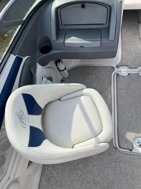 Slide: The Image of 2005 Monterey 194 FS boat interior with white and blue seating and storage compartment. - 8