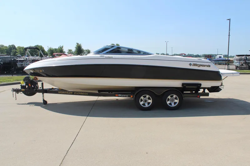 Slide: The Image of 2002 Bryant 234 boat on trailer in sunny outdoor setting. - 4