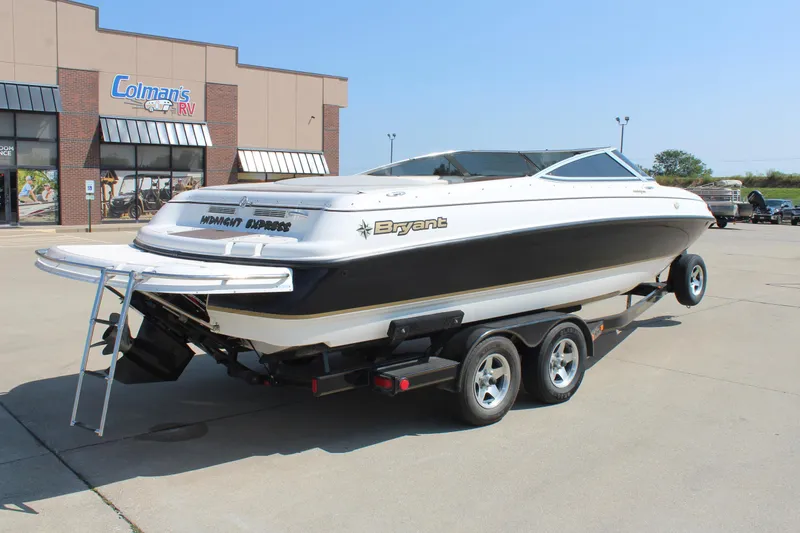 Slide: The Image of 2002 Bryant 234 boat on trailer outside Colman's RV dealership. - 6