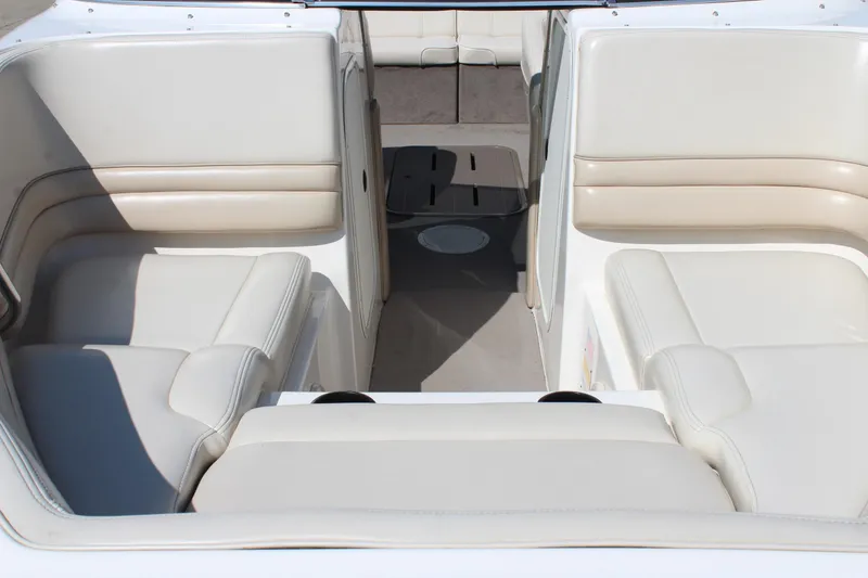 Slide: The Image of 2002 Bryant 234 boat interior with beige seating and spacious layout. - 7