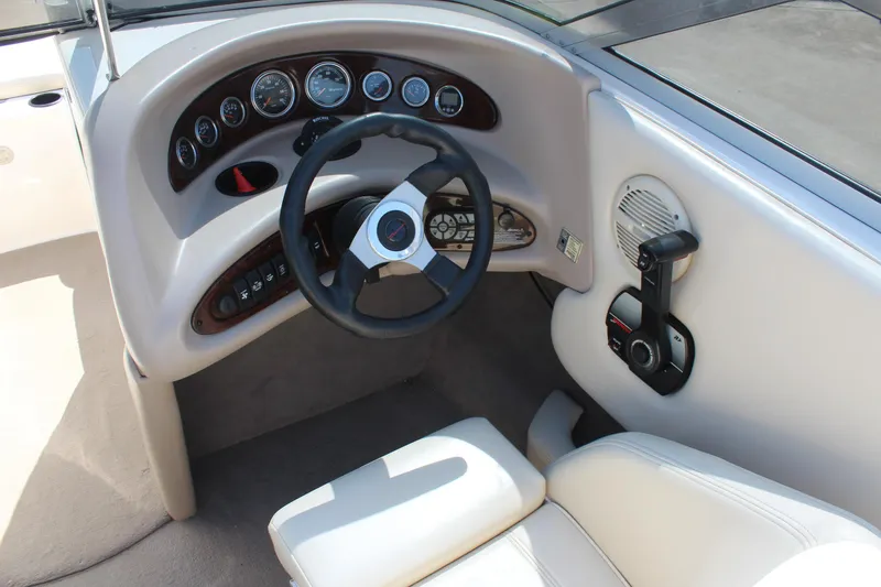 Slide: The Image of 2002 Bryant 234 boat dashboard with steering wheel and control panel. - 8