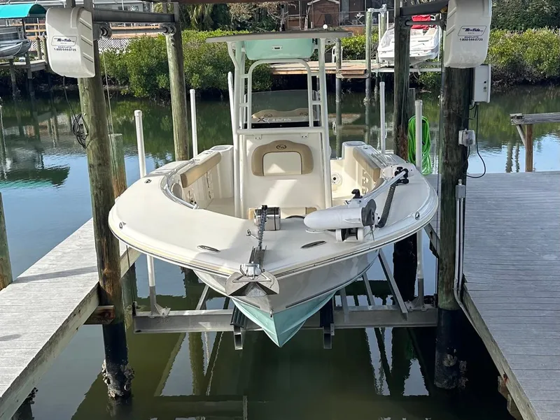 Slide: The Image of 2019 Key West 244 Center Console boat docked on a lift. - 14