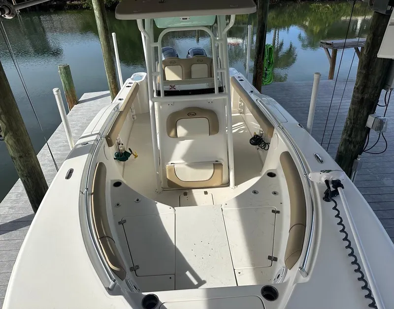 Slide: The Image of 2019 Key West 244 Center Console boat docked, featuring spacious seating and sleek design. - 25