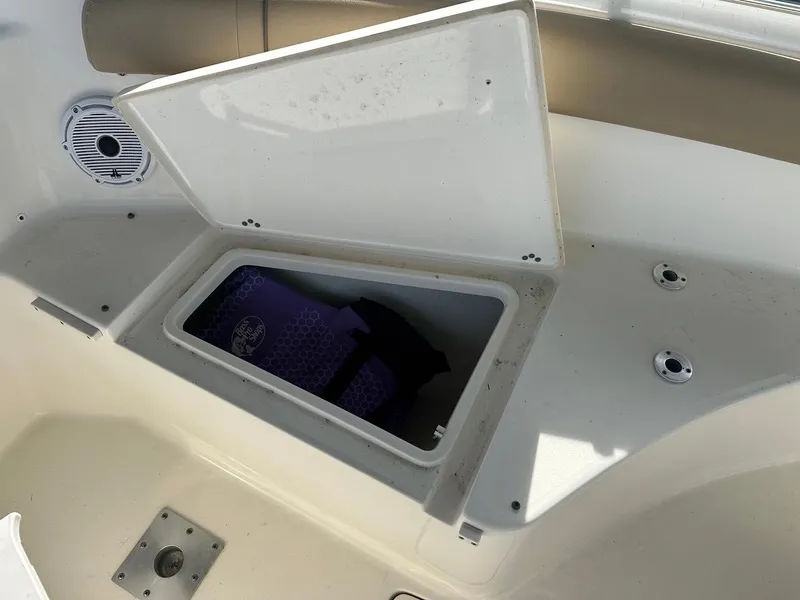 Slide: The Image of Open storage compartment on 2019 Key West 244 Center Console boat. - 28