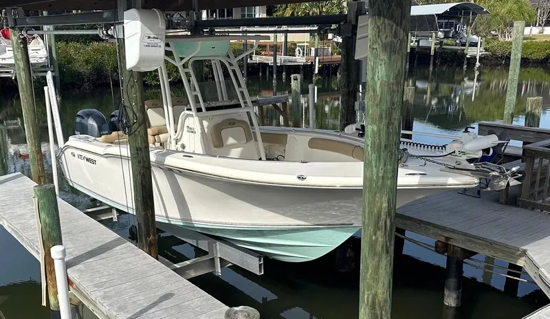 Slide: The Image of 2019 Key West 244 Center Console boat docked in a marina. - 3