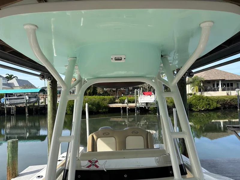 Slide: The Image of 2019 Key West 244 Center Console boat docked in a serene waterfront setting. - 30