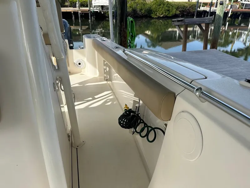 Slide: The Image of 2019 Key West 244 Center Console boat docked by a serene waterfront. - 32