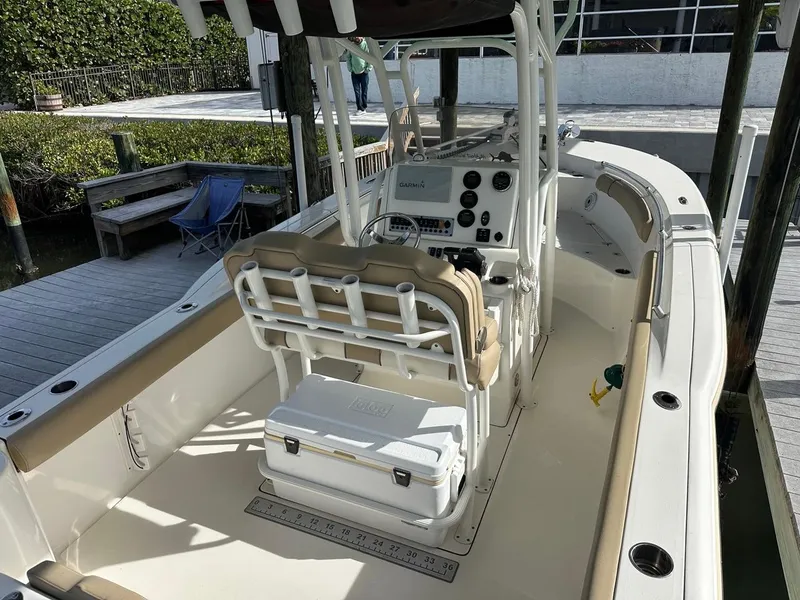 Slide: The Image of 2019 Key West 244 Center Console boat docked, featuring spacious seating and modern controls. - 38