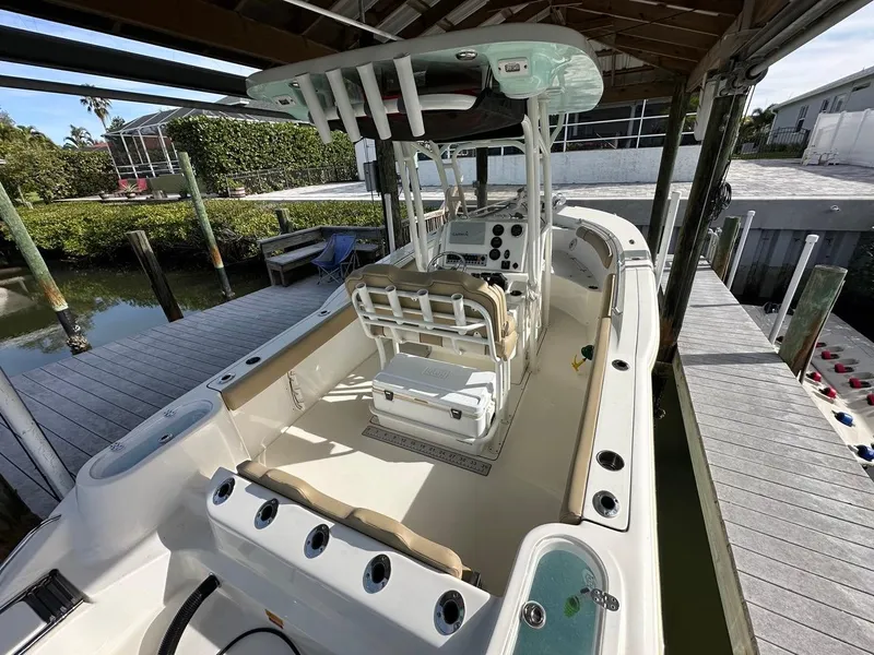 Slide: The Image of 2019 Key West 244 Center Console boat docked, featuring spacious seating and modern controls. - 39