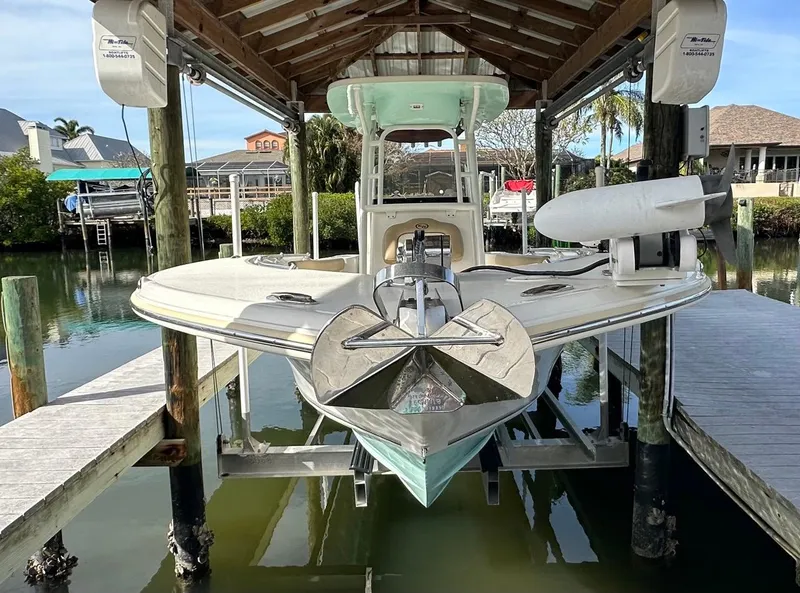 Slide: The Image of 2019 Key West 244 Center Console boat docked under a wooden shelter. - 4