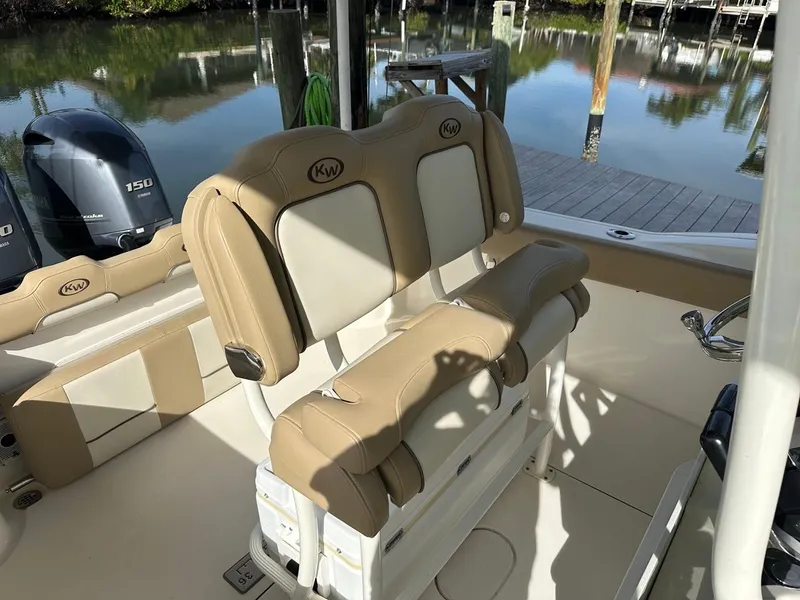 Slide: The Image of 2019 Key West 244 Center Console boat interior with tan seating and outboard motor. - 41