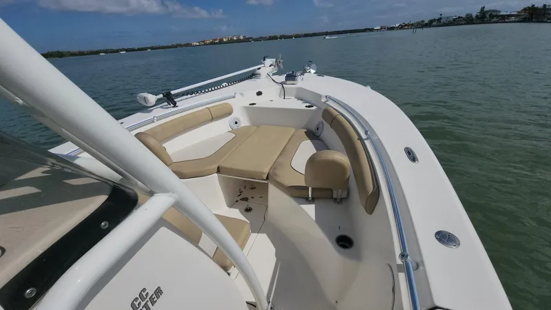 Slide: The Image of 2019 Key West 244 Center Console boat on calm water, featuring spacious seating and sleek design. - 44