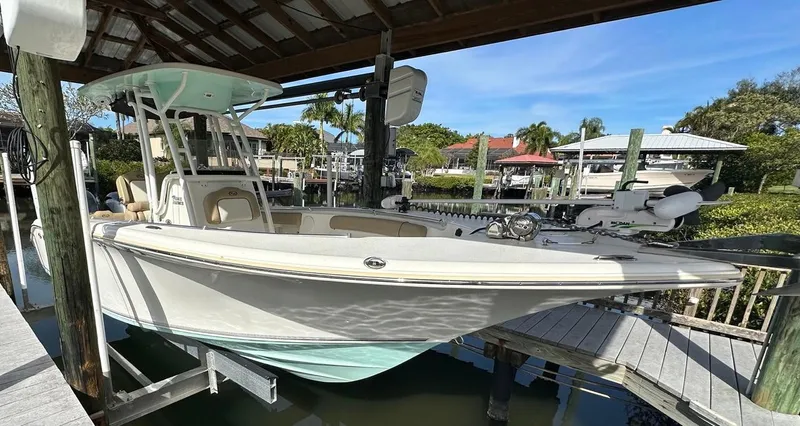 Slide: The Image of 2019 Key West 244 Center Console boat docked under a covered marina. - 7