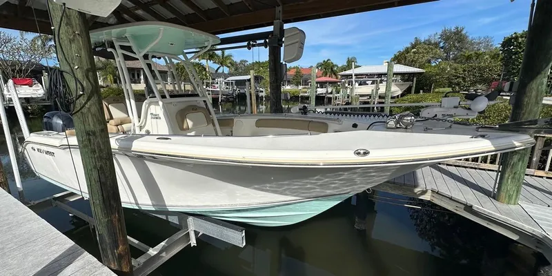Slide: The Image of 2019 Key West 244 Center Console boat docked under a covered marina. - 8