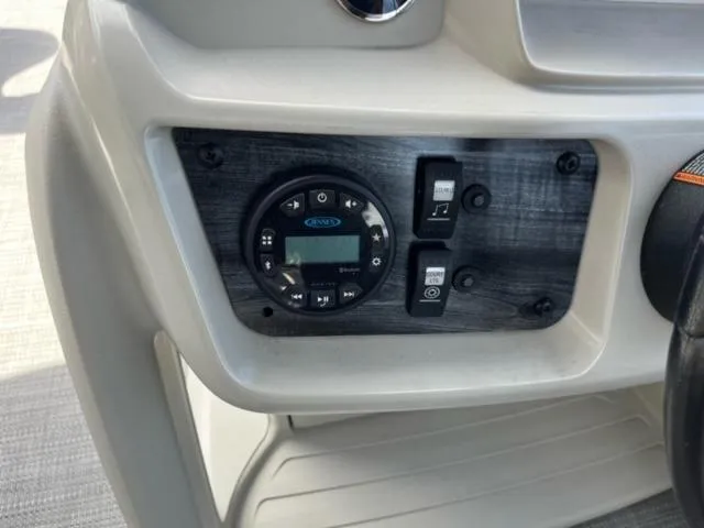 Slide: The Image of Control panel of 2023 SunChaser Vista 18 Fish boat with audio system and switches. - 10