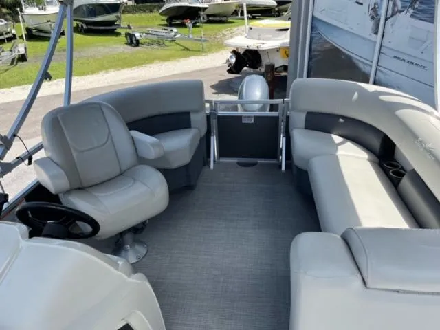 Slide: The Image of 2023 SunChaser Vista 18 Fish pontoon boat interior with plush seating and steering console. - 8