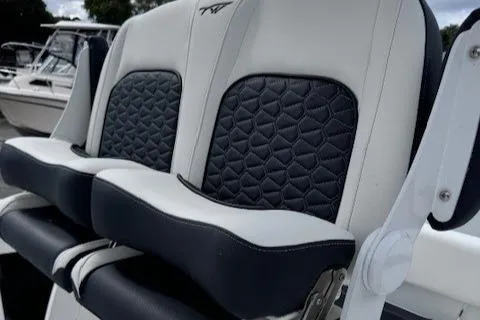 Slide: The Image of 2025 Tidewater 220 CC Adventure boat seats with black and white upholstery. - 15