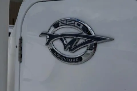 Slide: The Image of Tidewater 220 CC Adventure 2025 logo on white boat surface. - 17