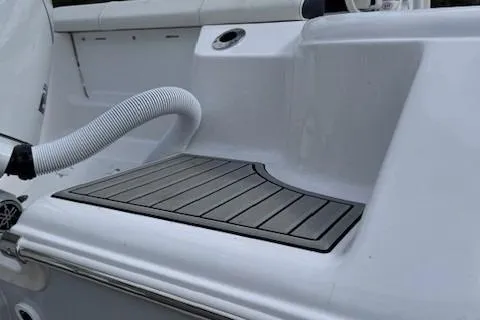 Slide: The Image of 2025 Tidewater 220 CC Adventure boat deck with non-slip surface and hose attachment. - 19