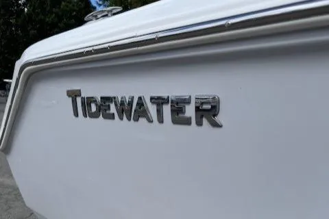 Slide: The Image of 2025 Tidewater 220 CC Adventure boat, close-up of logo on white hull. - 4