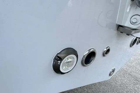 Slide: The Image of Close-up of 2025 Tidewater 220 CC Adventure boat hull with fittings and light. - 7