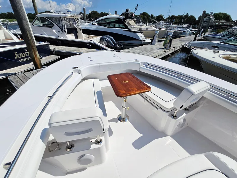 Slide: The Image of 2022 Southport 30 FE boat with seating and wooden table at marina. - 10