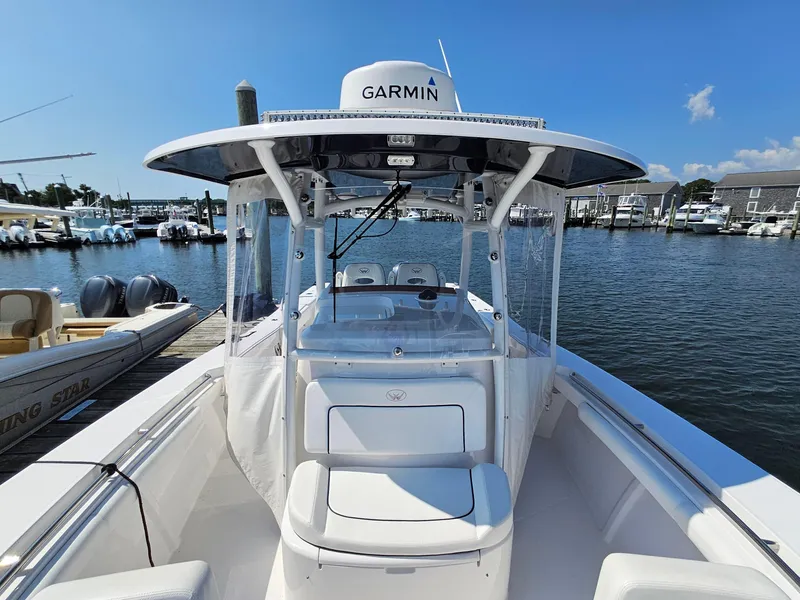 Slide: The Image of 2022 Southport 30 FE boat docked with Garmin equipment, clear skies, and marina backdrop. - 11