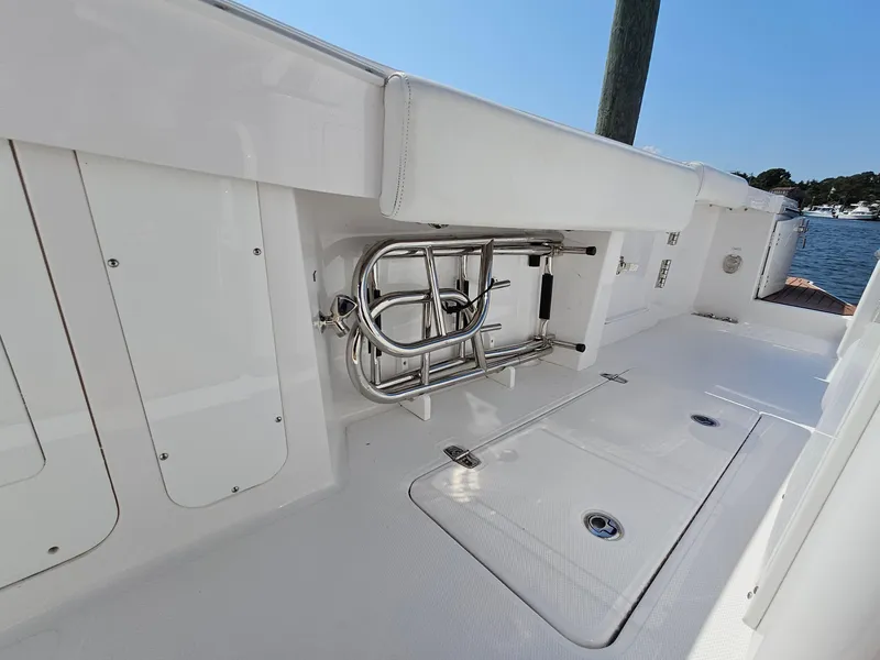 Slide: The Image of 2022 Southport 30 FE boat deck with storage compartments and stainless steel fixtures. - 13