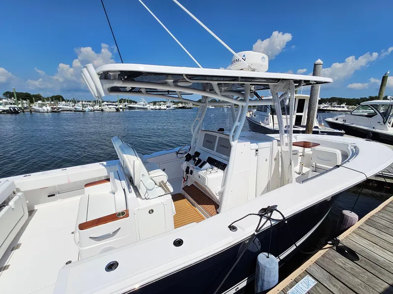 Slide: The Image of 2022 Southport 30 FE boat docked at marina under clear blue sky. - 3