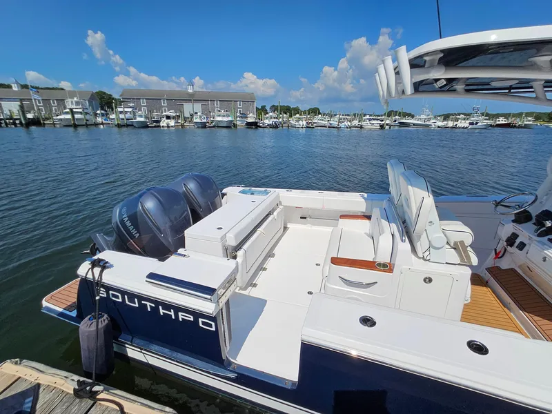 Slide: The Image of 2022 Southport 30 FE boat docked in a marina with twin engines. - 4