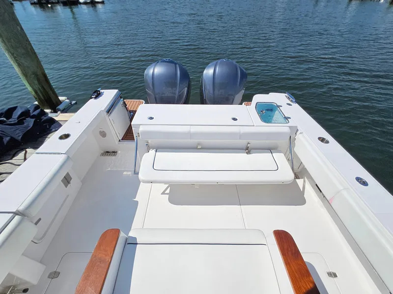 Slide: The Image of 2022 Southport 30 FE boat deck with dual engines, spacious seating, and fishing amenities. - 5