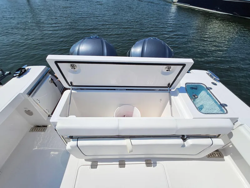 Slide: The Image of 2022 Southport 30 FE boat with open storage compartment and twin engines on water. - 6