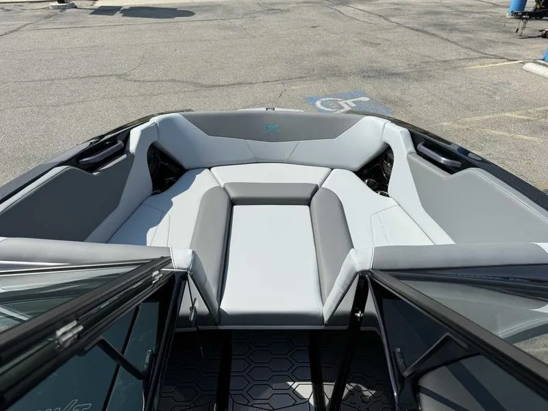 Slide: The Image of 2025 MasterCraft NXT22 boat interior with sleek gray seating and modern design. - 10