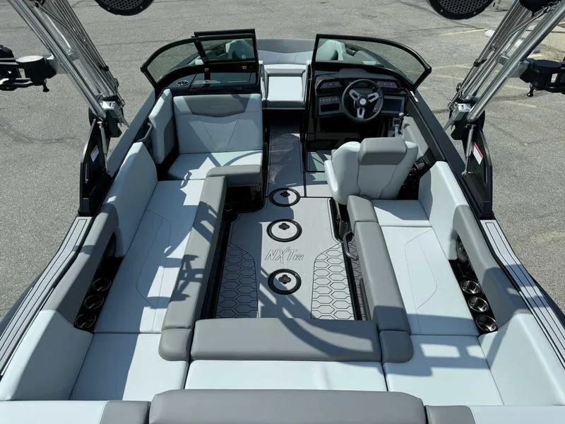 Slide: The Image of 2025 MasterCraft NXT22 boat interior with spacious seating and modern design. - 7