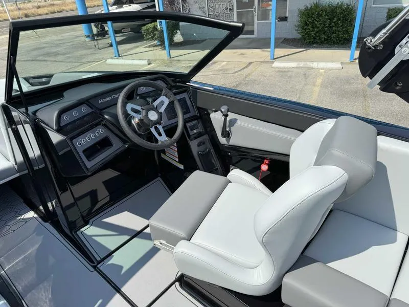 Slide: The Image of 2025 MasterCraft NXT22 boat interior with modern steering and seating. - 9