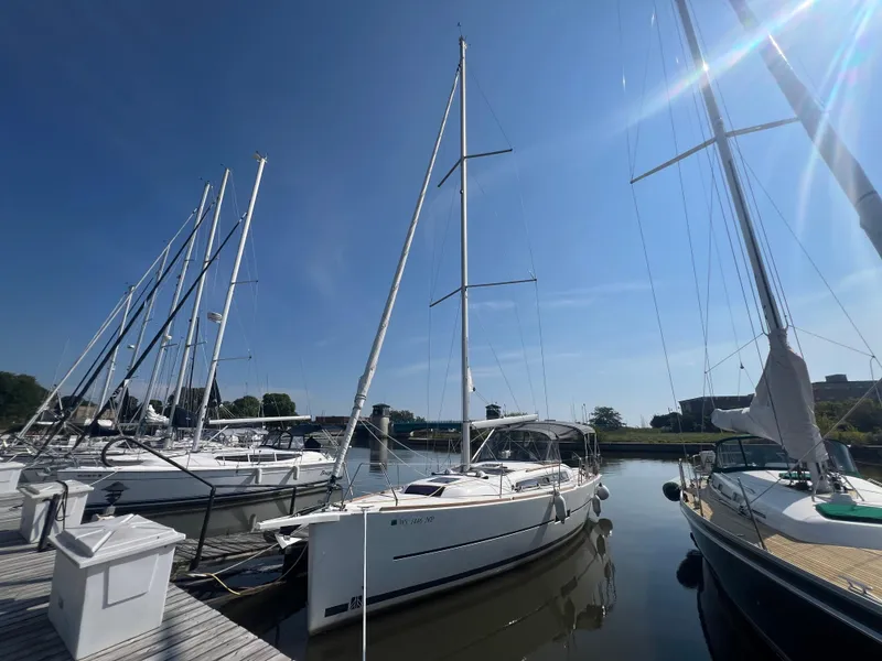 Slide: The Image of 2021 Dufour 360 sailboat docked in a sunny marina. - 1