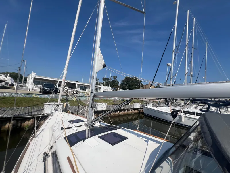 Slide: The Image of 2021 Dufour 360 sailboat docked at marina under clear blue sky. - 15