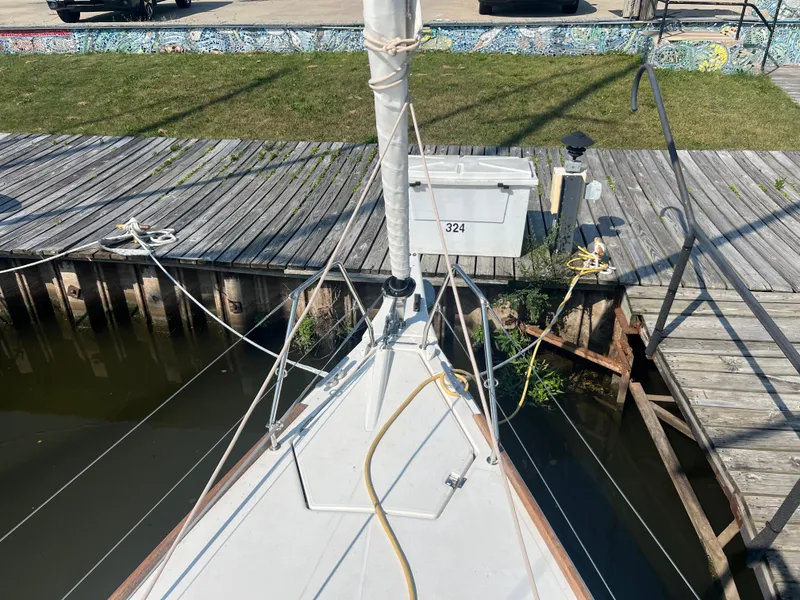 Slide: The Image of Dufour 360 sailboat docked, showing deck and rigging, 2021 model. - 16