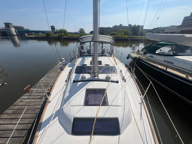 Slide: The Image of Dufour 360 sailboat, 2021 model, docked in a calm marina setting. - 18