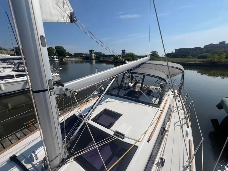 Slide: The Image of Dufour 360 sailboat, 2021 model, docked in a serene marina setting. - 20