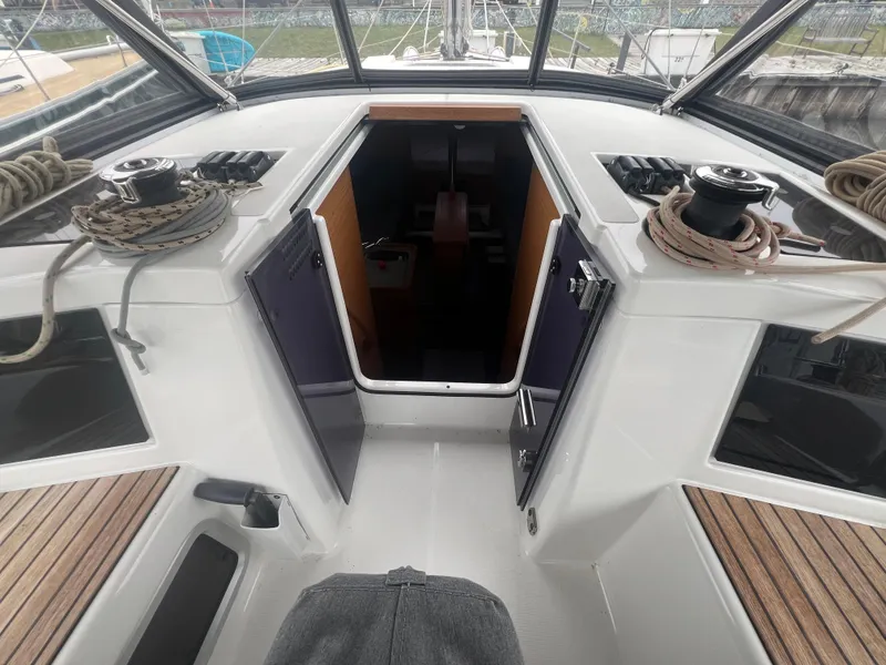Slide: The Image of Dufour 360 sailboat cockpit, 2021 model, featuring open cabin doors and deck equipment. - 21