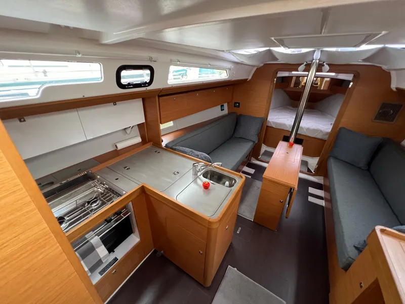 Slide: The Image of Interior of 2021 Dufour 360 yacht with modern kitchen and cozy seating area. - 23